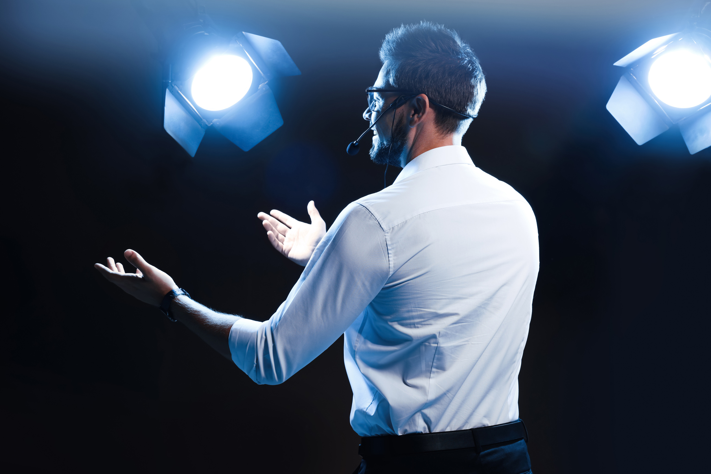Motivational Speaker with Headset Performing on Stage